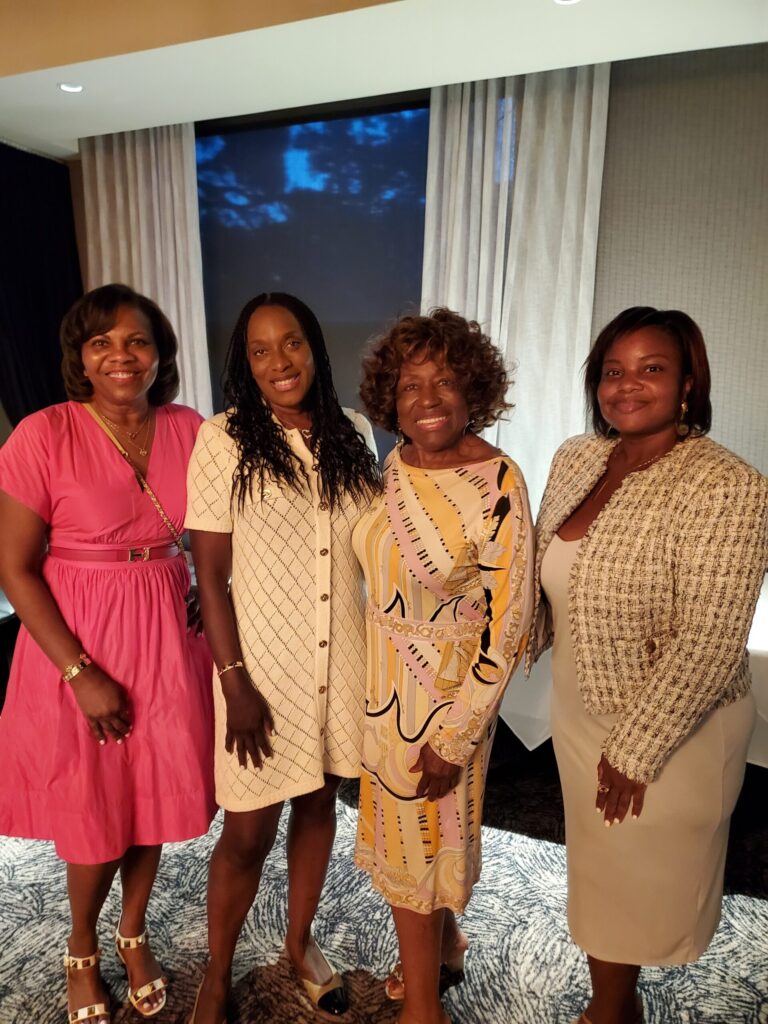 Group of four women at Homesafe event in a modern room.