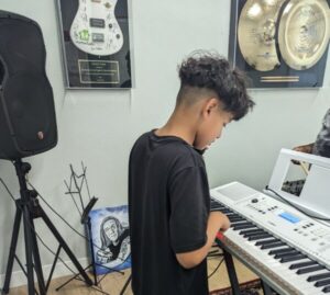 twelve-year-old Patrick playing keyboard