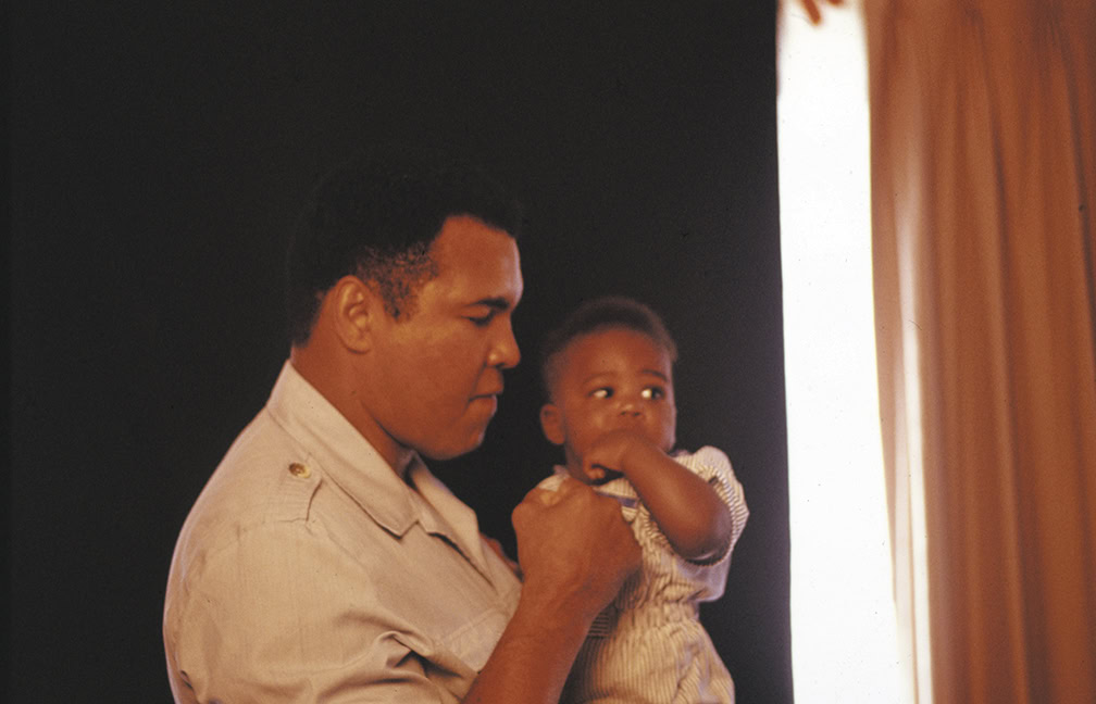 Father and child near window, emphasizing home safety and protection.